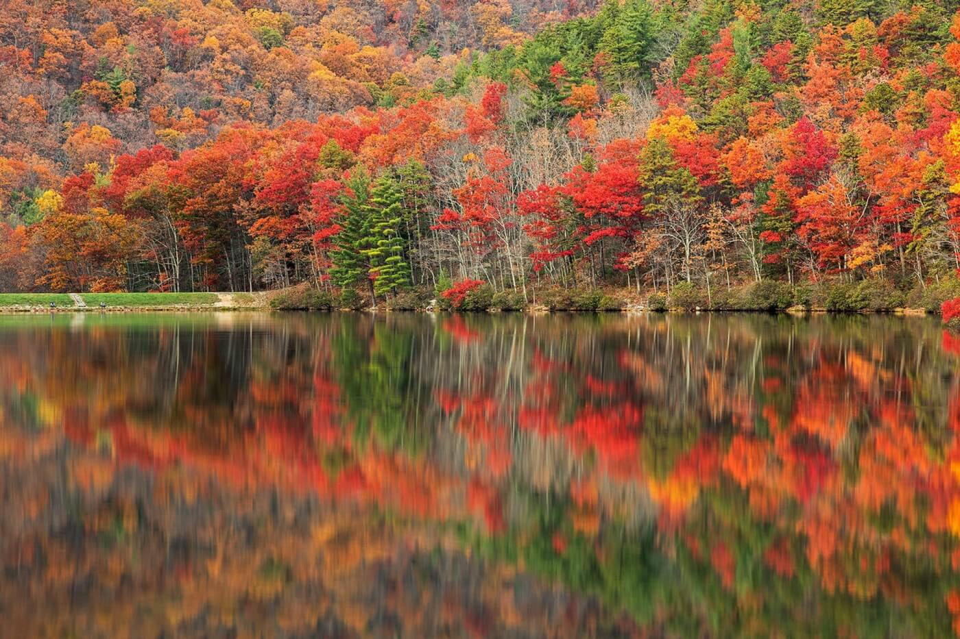 Autumn foliage reflected in a calm lake in the Blue Ridge Mountains of Virginia, USA.
