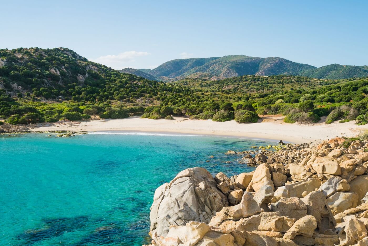Secluded beach in Sardinia with calm waters in June.