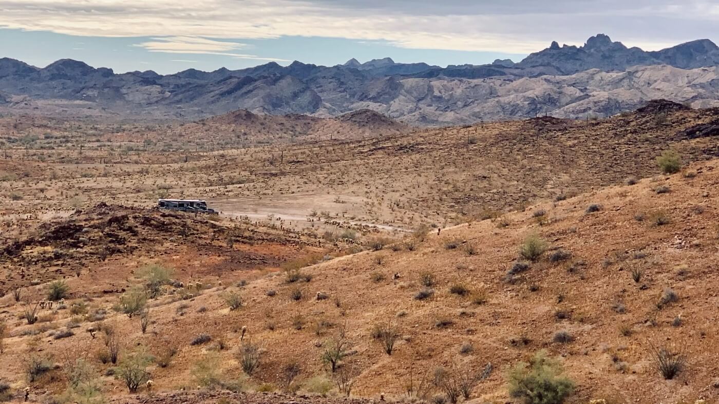 RV boondocking in vast Kofa desert valley beneath rugged Arizona peaks