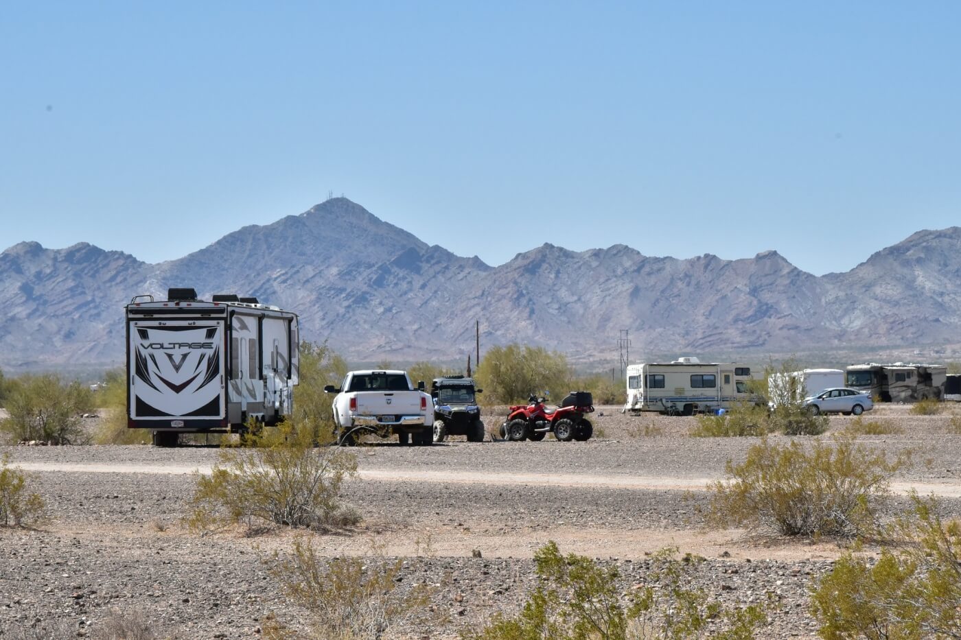 RVs and ATVs boondocked on open La Posa desert plain near Quartzsite AZ