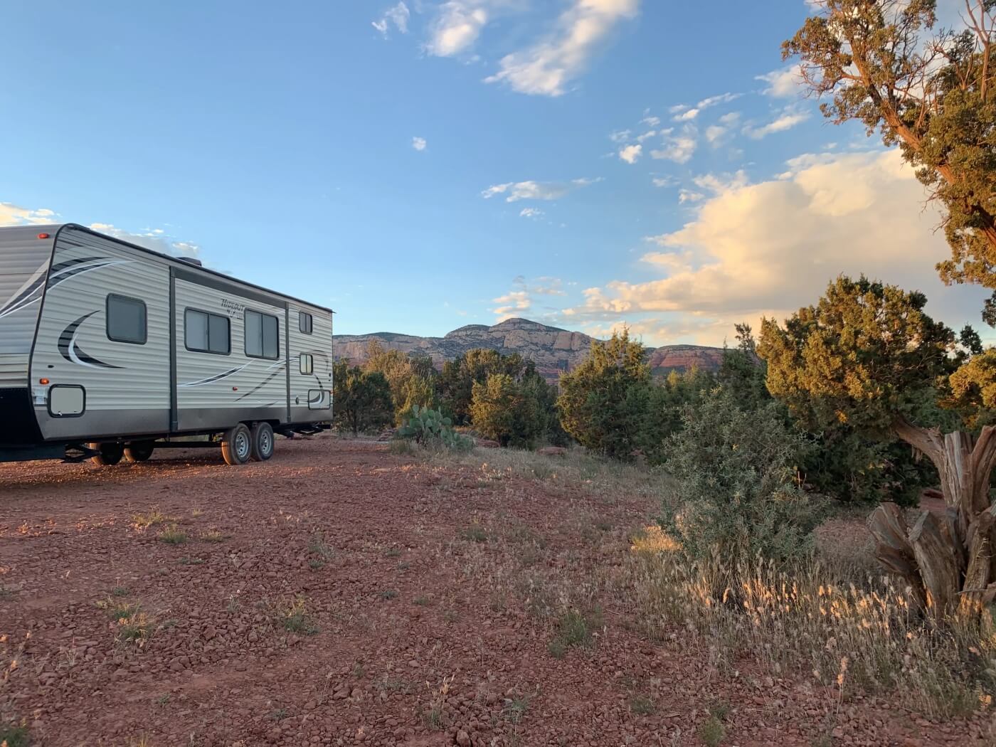 Travel trailer boondocked on red dirt clearing at Sedona’s Forest Road 525