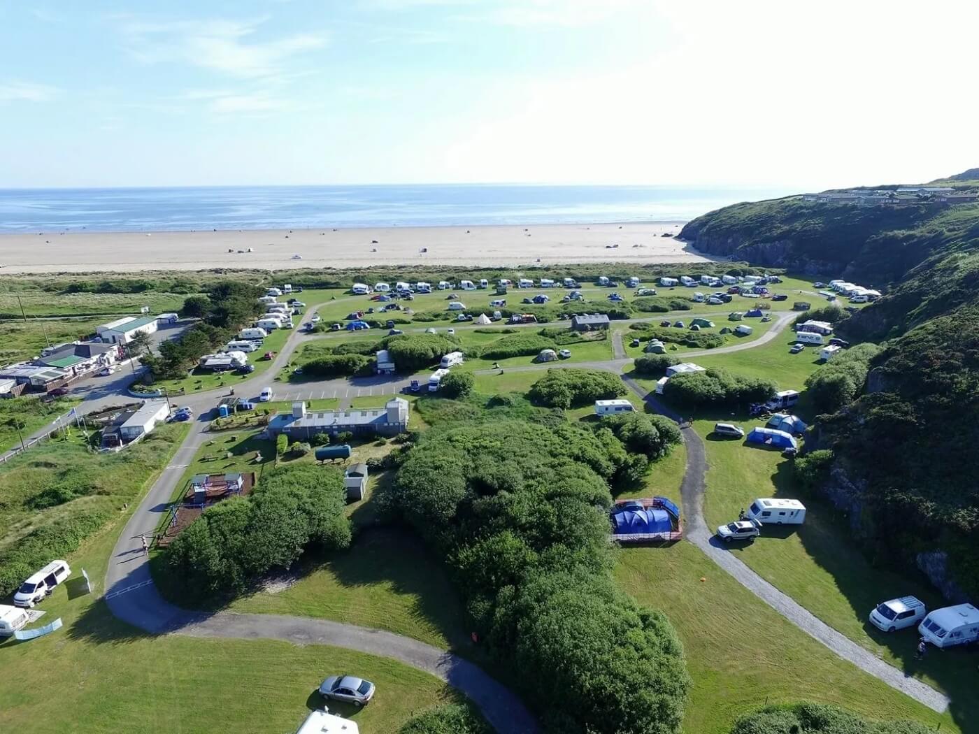 Aerial view of Black Rock Caravan and Camping Park by the beach.