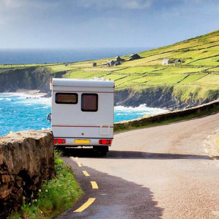 motorhome parked on a road in Ireland near the sea.